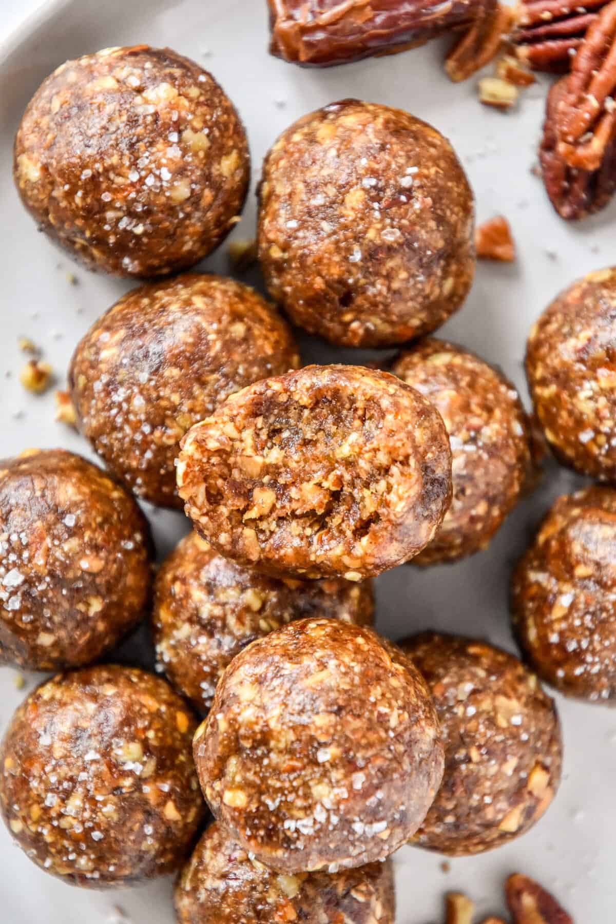 No Bake Pecan Pie Date Balls stacked on a plate.