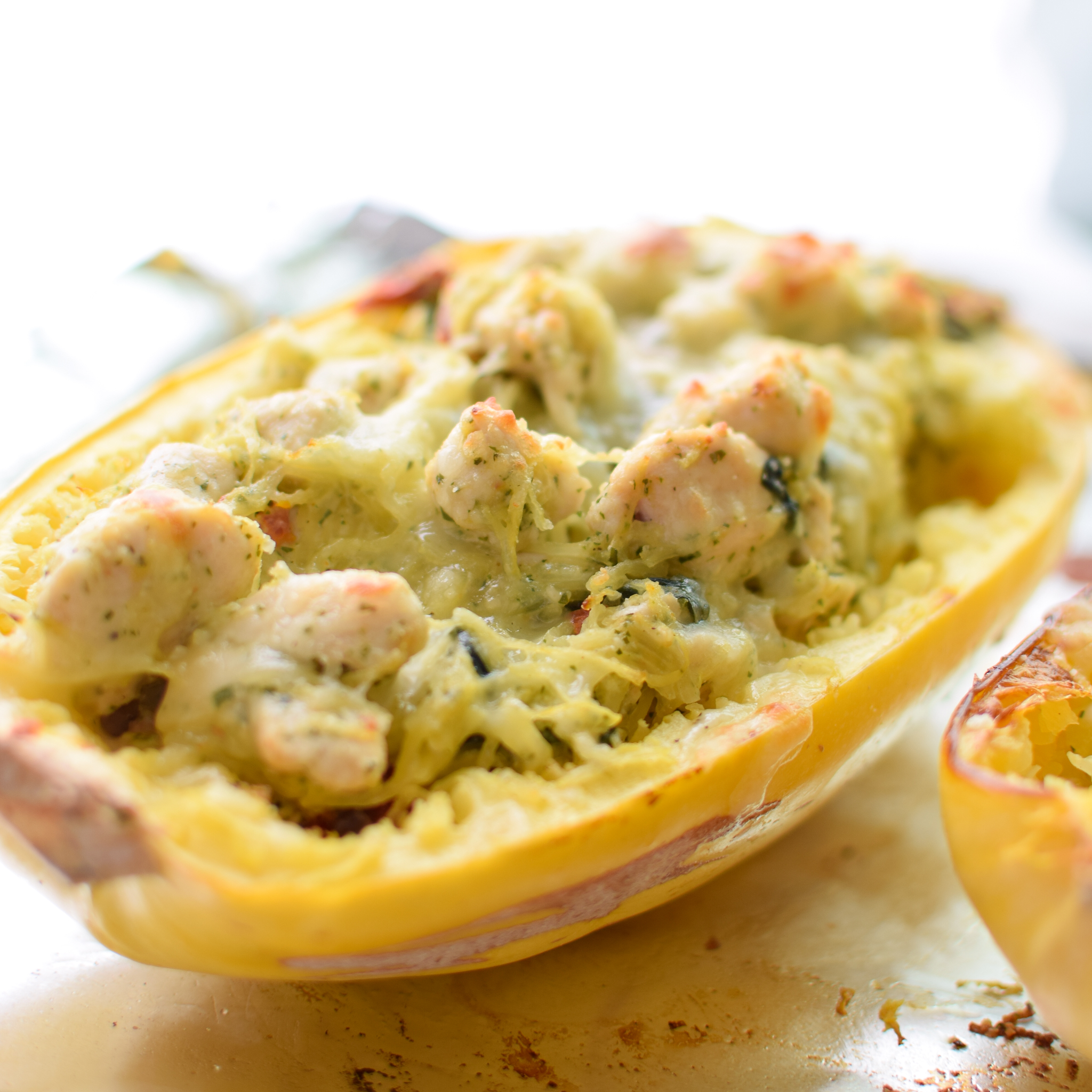 Pesto Chicken Stuffed Spaghetti Squash - Pesto, chicken, spinach, and a little greek yogurt for creamy goodness! Super healthy dinner for two! - ProjectMealPlan.com