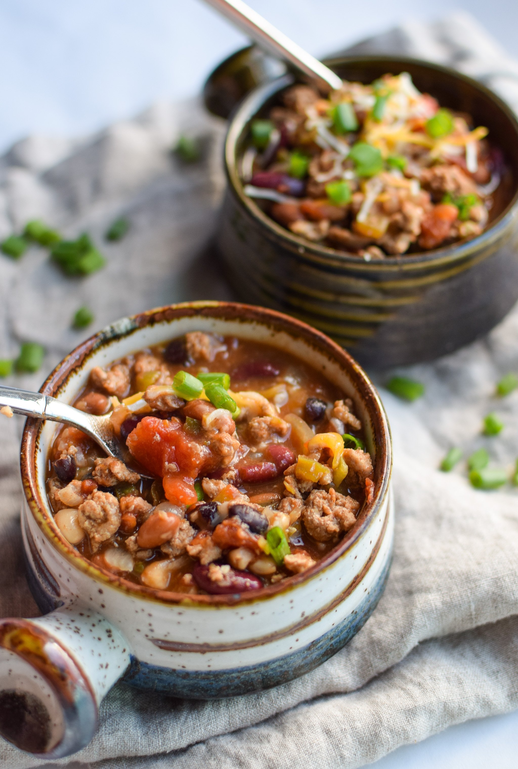 Easy Slow Cooker 4-Bean Turkey Chili recipe - A slow cooker classic that should be in everyone's cookbook! A hearty bean and turkey chili with some smokey kick! - ProjectMealPlan.com