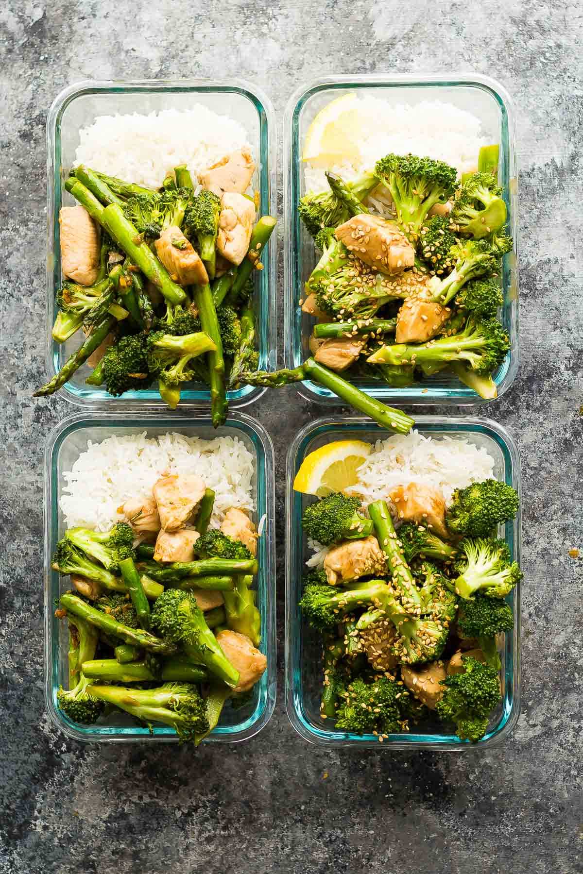 Four bowls of asparagus broccoli chicken stir fry with rice.