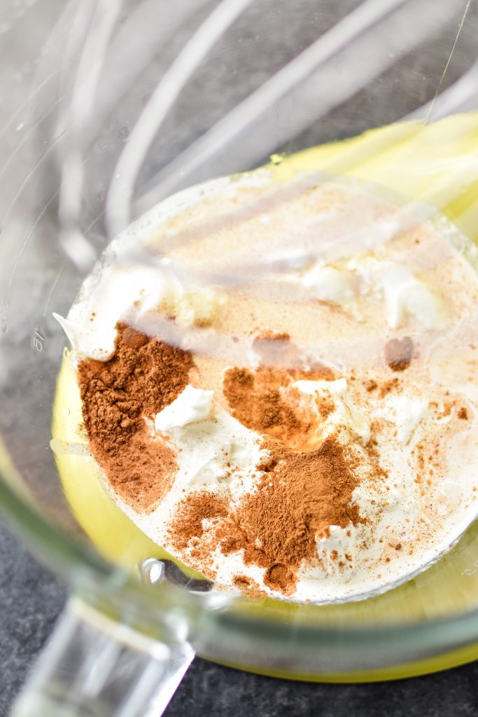 ingredients for Pumpkin Spice Whipped Greek Yogurt in a bowl of a stand mixer.