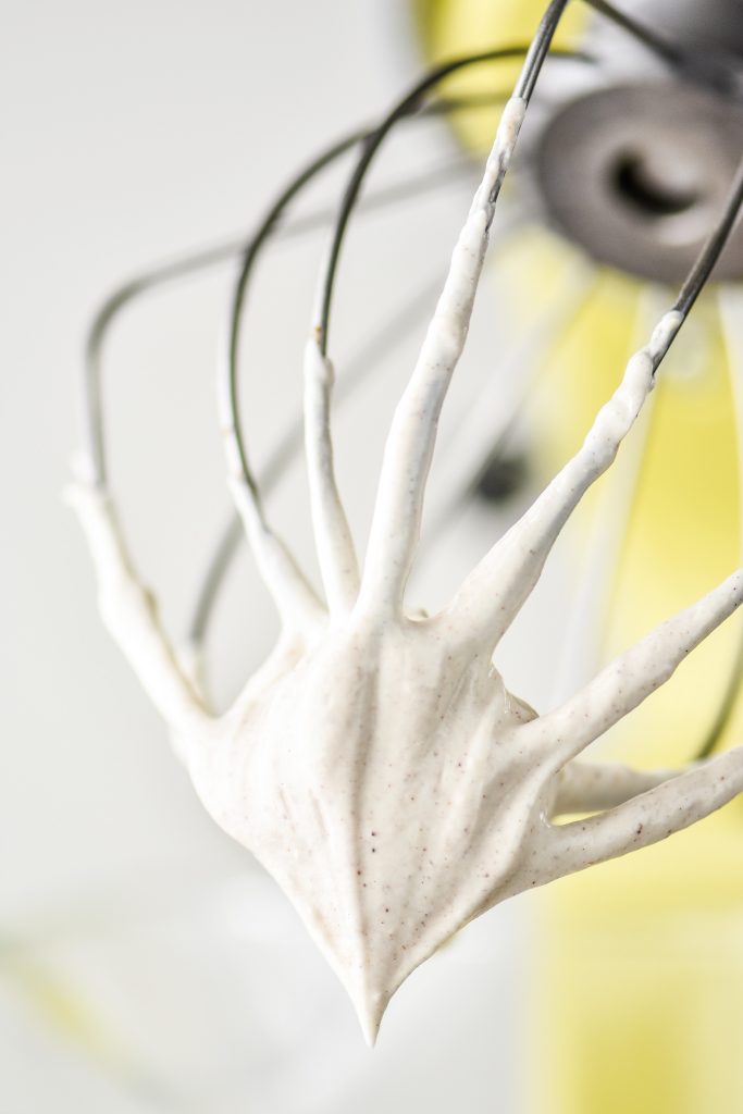 whipped greek yogurt on a whisk after whipping.