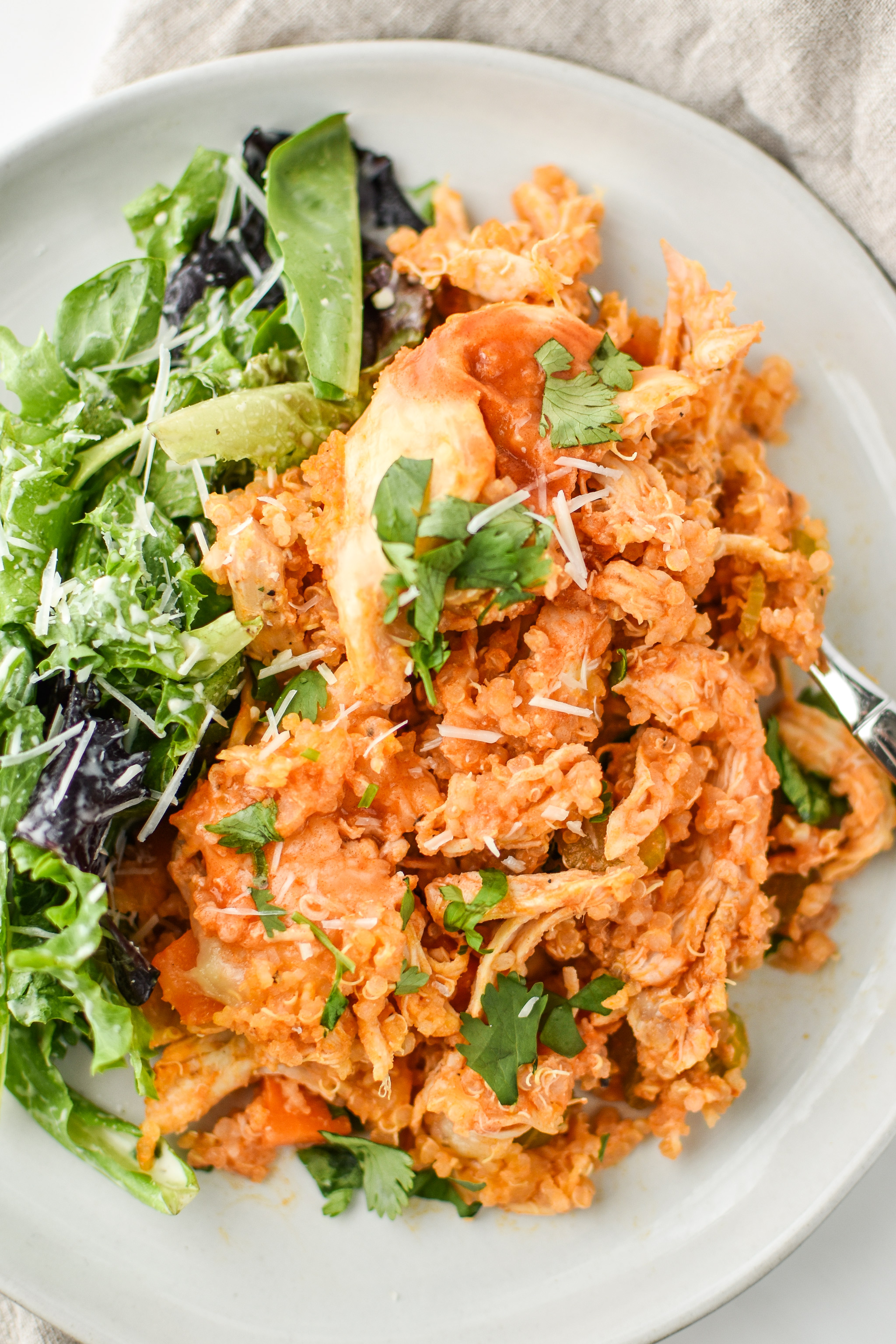 Buffalo Chicken Quinoa Bake served with salad.