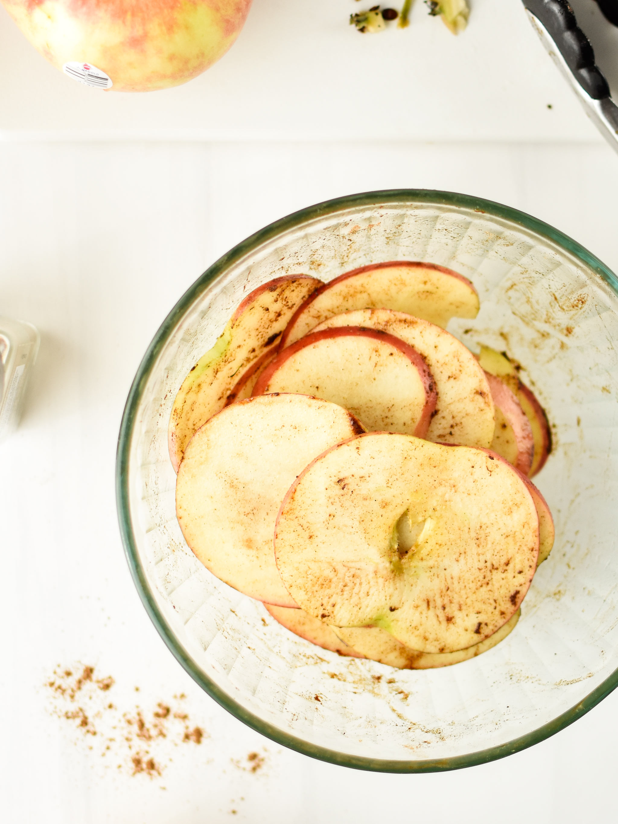 Season apple slices with cinnamon to make apple chips in an air fryer