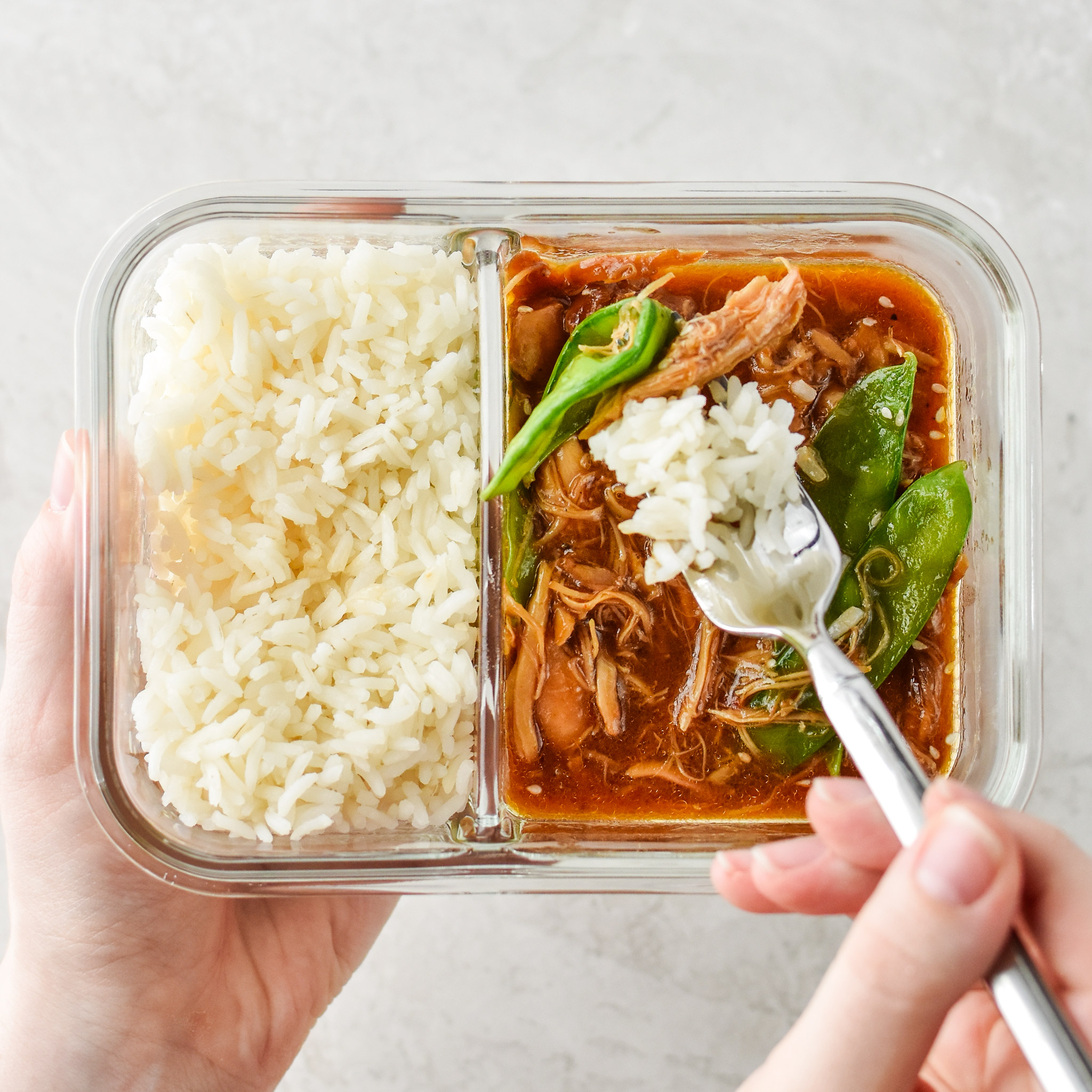 Honey Garlic chicken Meal prep bowls made in the Instant pot, pictured in a glass meal prep container in hand with rice. Meal Prep Lunch Recipes