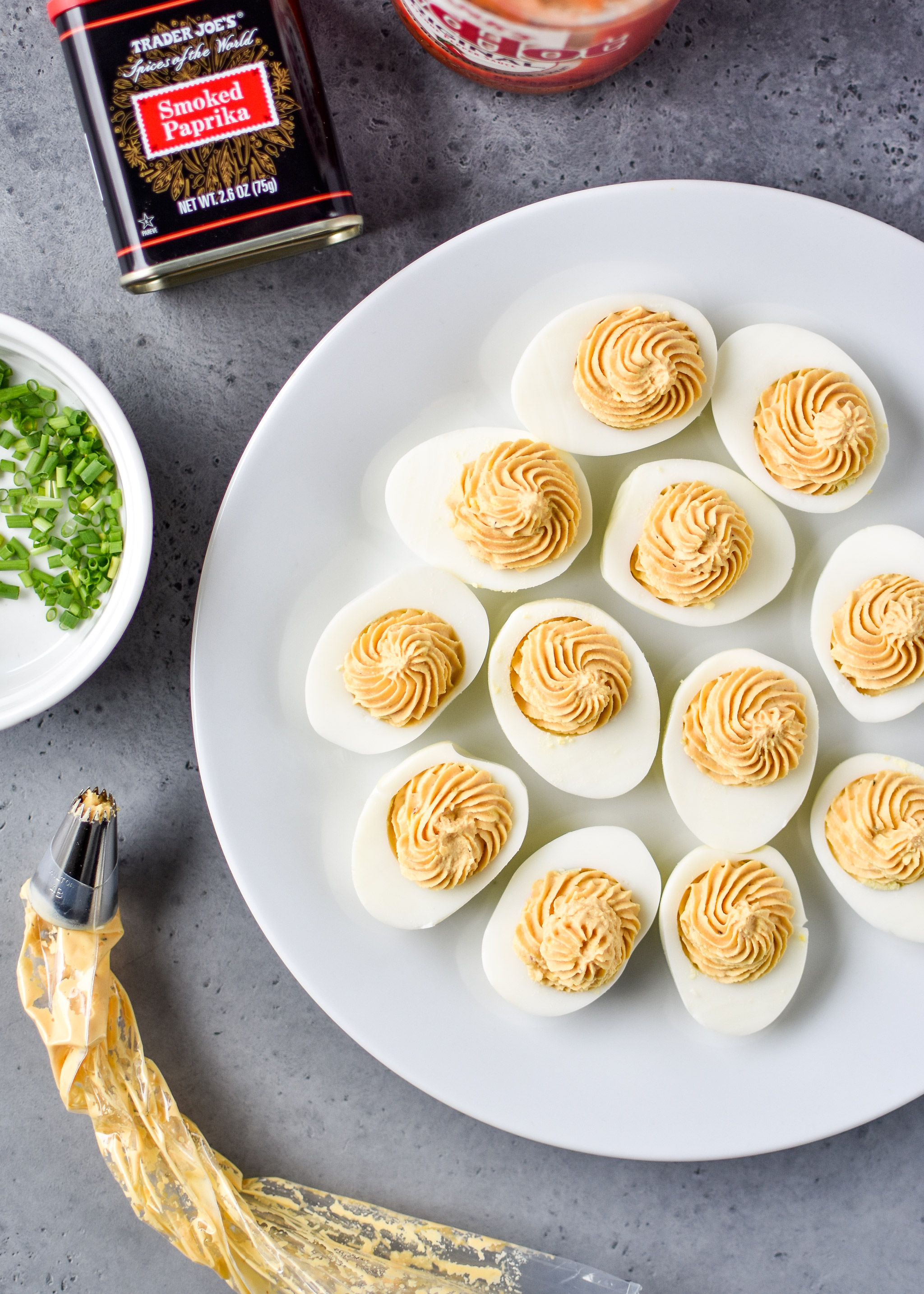 Whole30 Buffalo Deviled Eggs with the yolk mixture just piped into the egg whites.