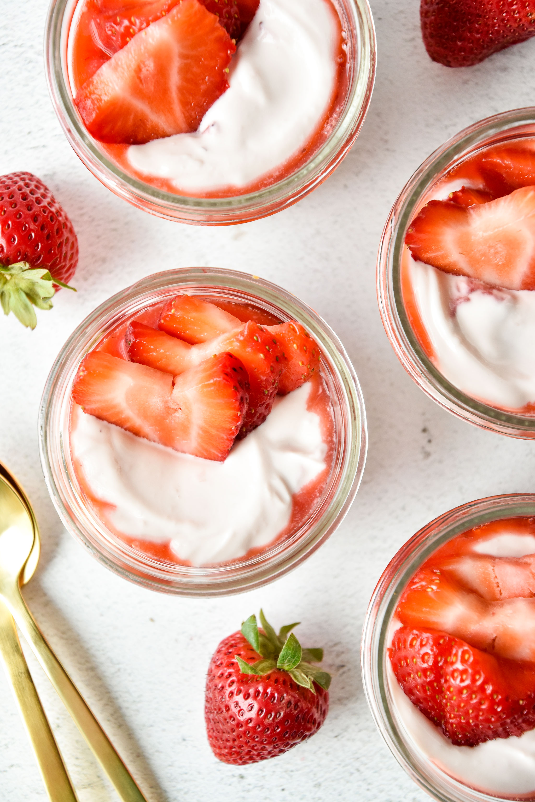 strawberry whipped yogurt cups with fresh strawberries on top