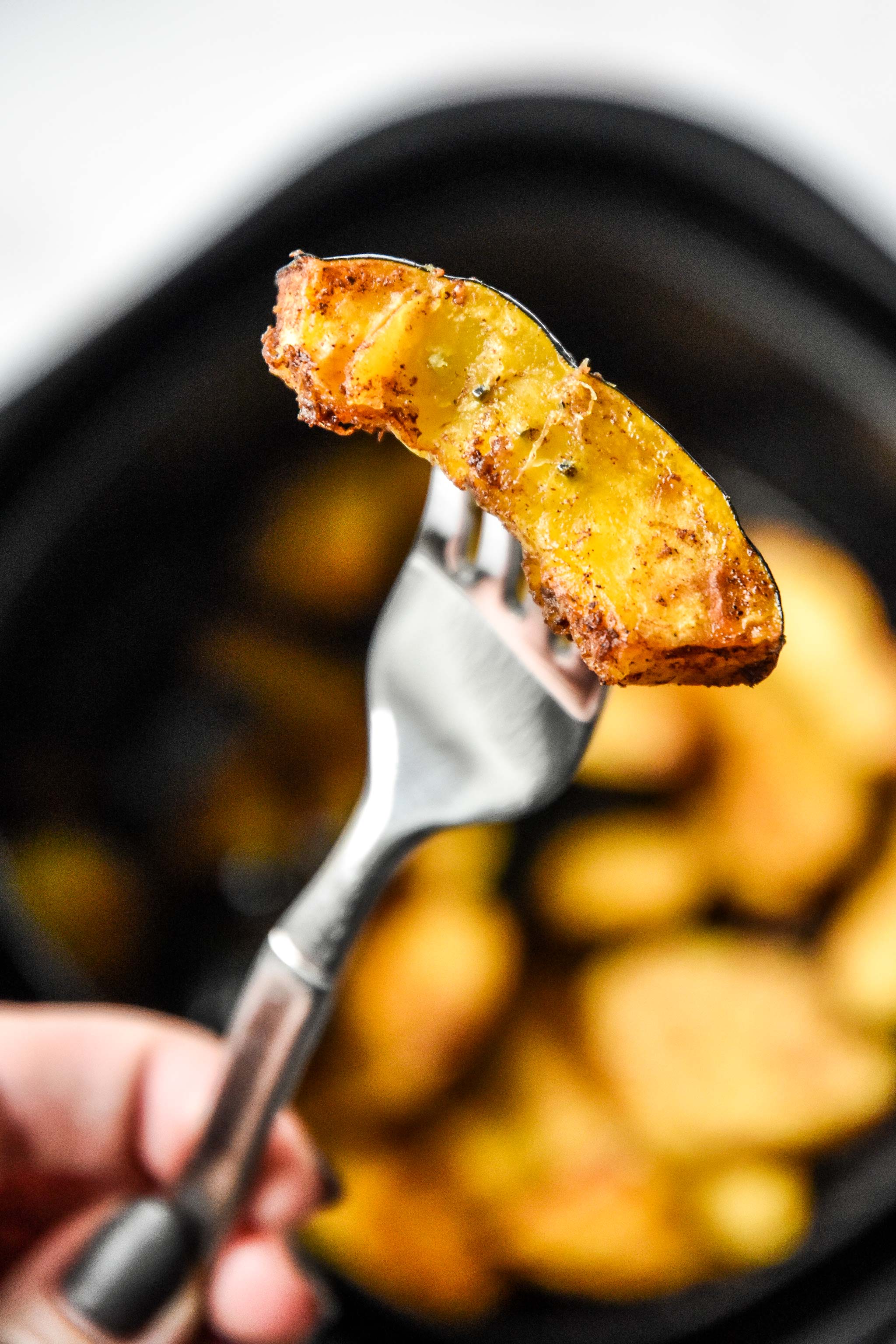 sweet air fryer acorn squash on a fork