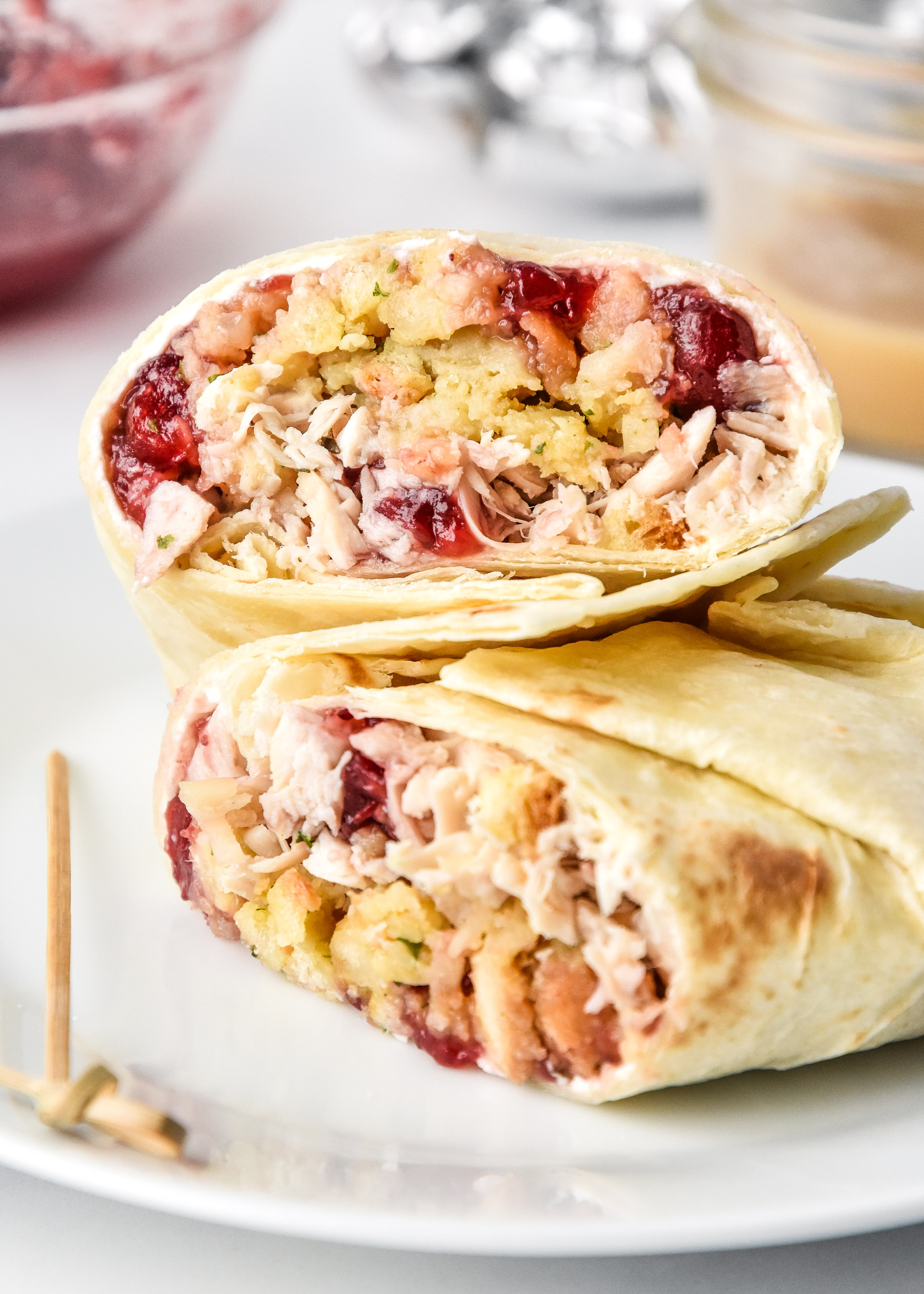 turkey gobbler wrap made with leftover ingredients cut in half on a plate