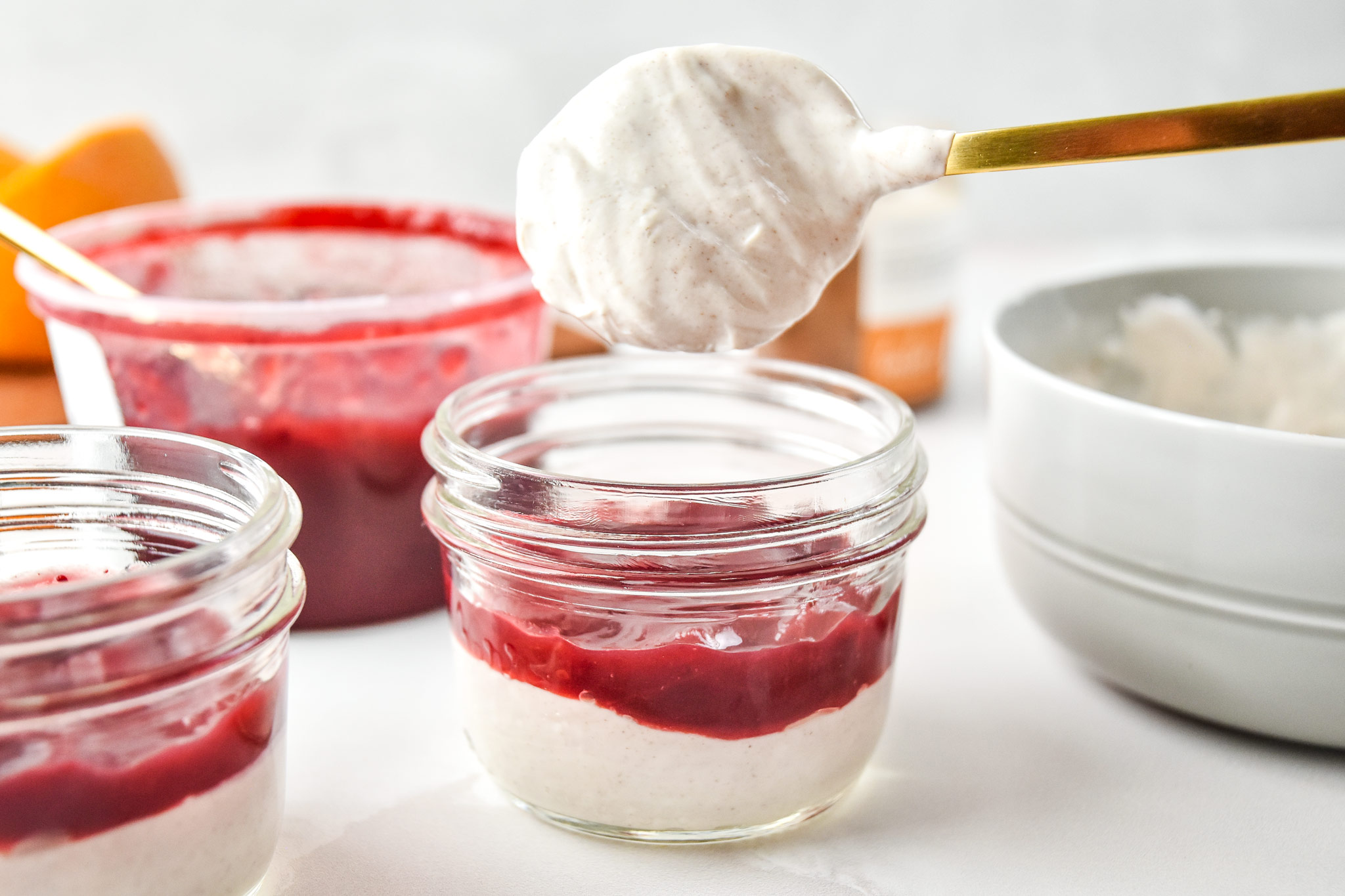 spooning cinnamon orange yogurt into the mason jar