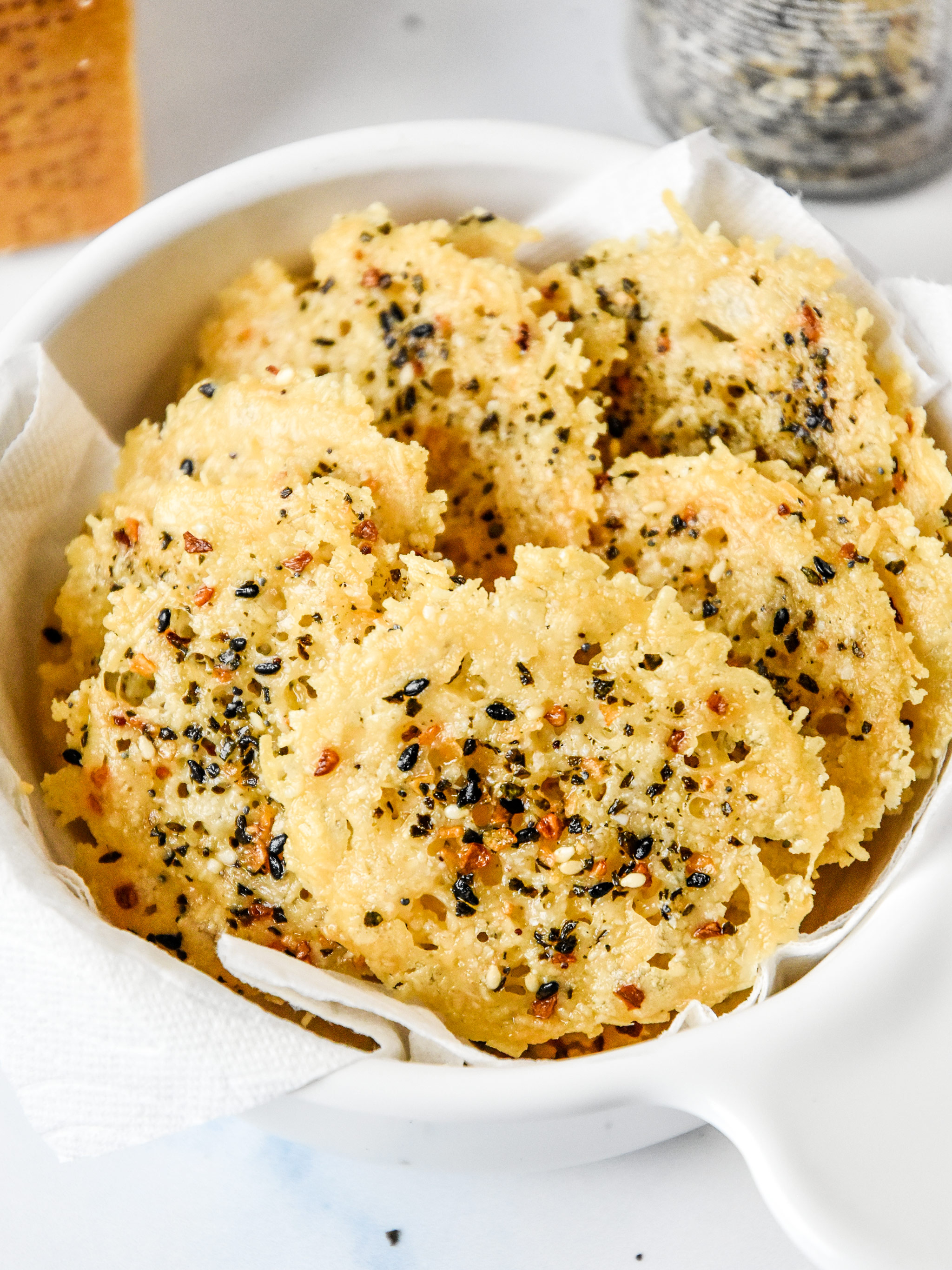 everything bagel baked parmesan crisps in a white bowl