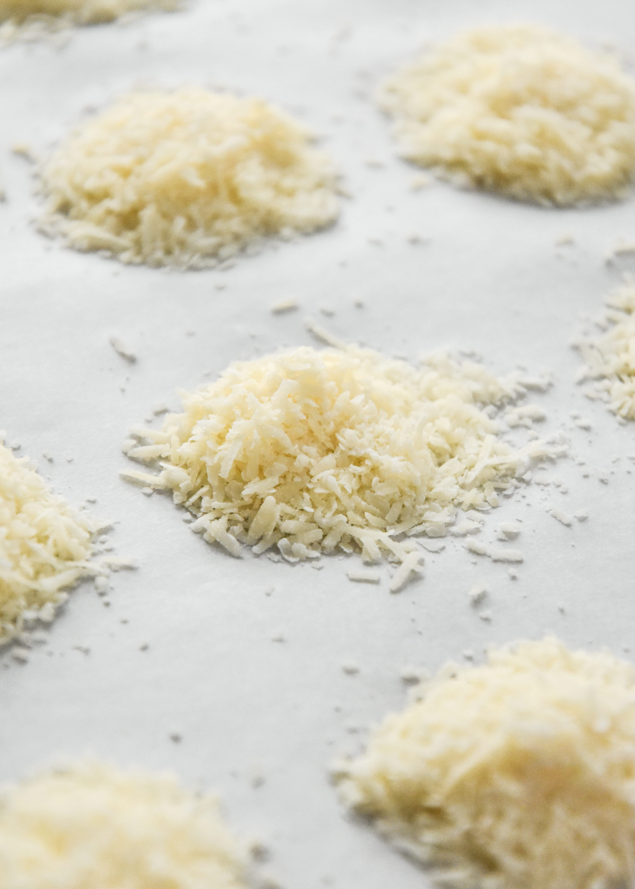 piles of parmesan cheese on a baking sheet