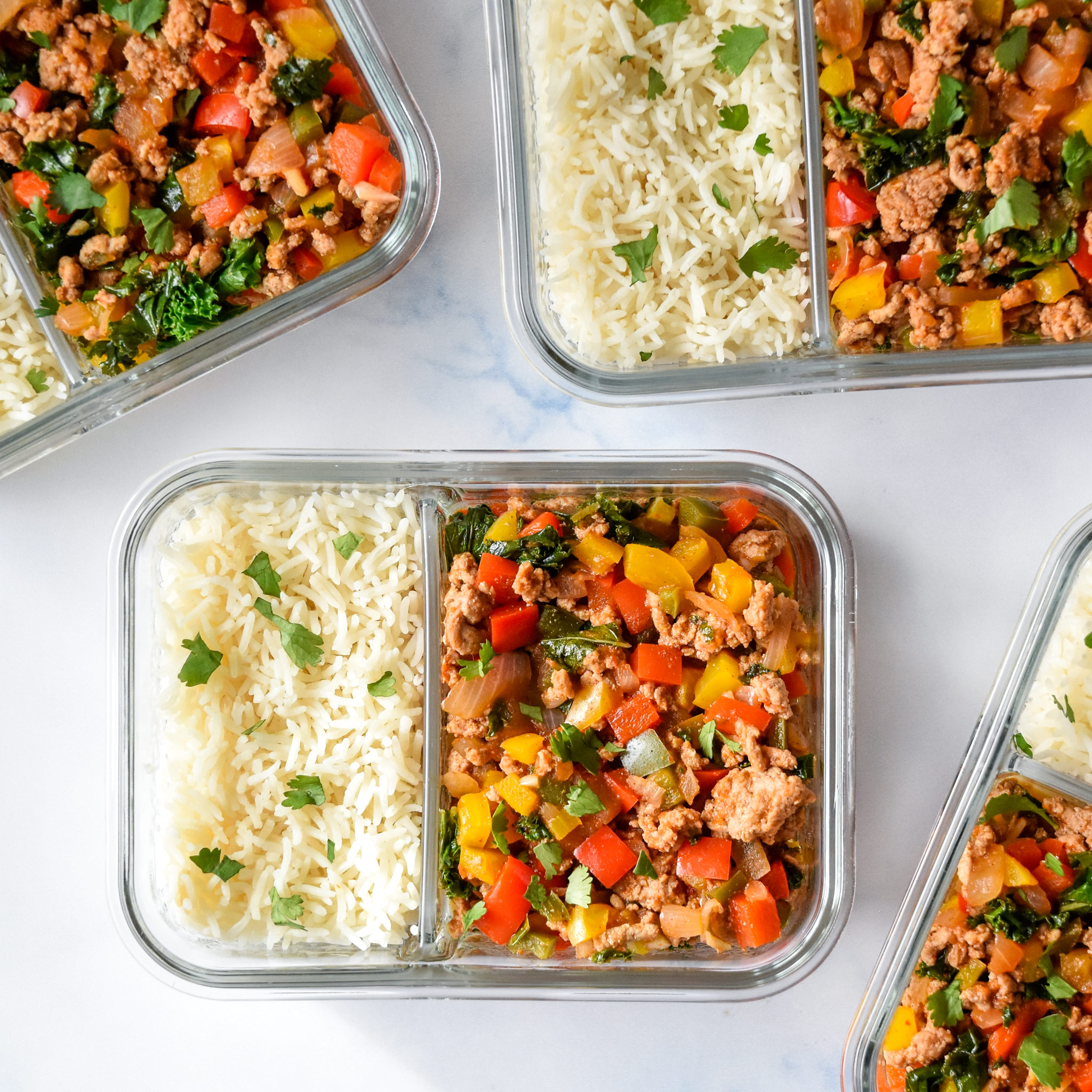 chipotle ground turkey skillet meal prep in glass containers with rice