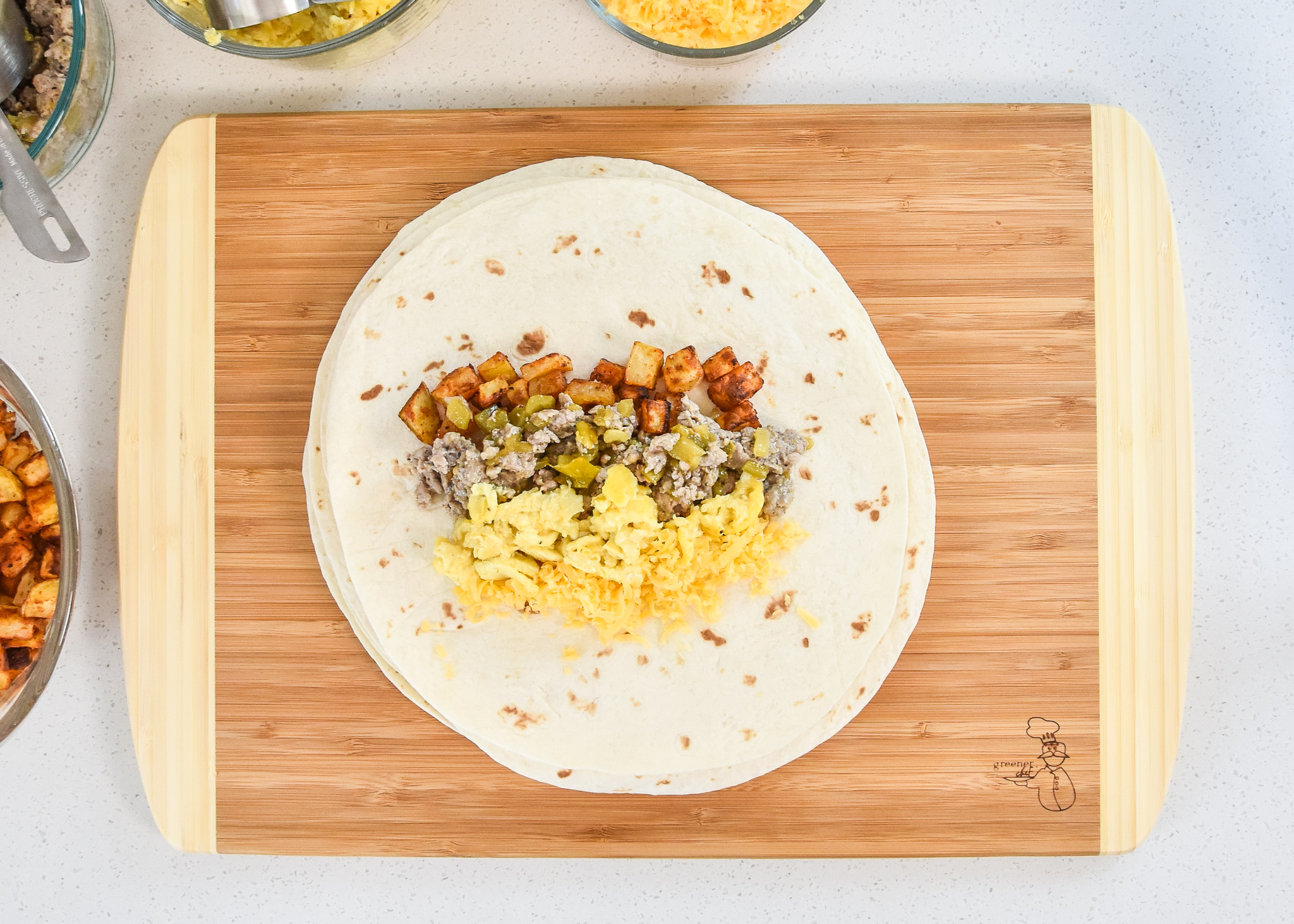all the ingredients in the air fryer breakfast burritos on a tortilla before being wrapped up