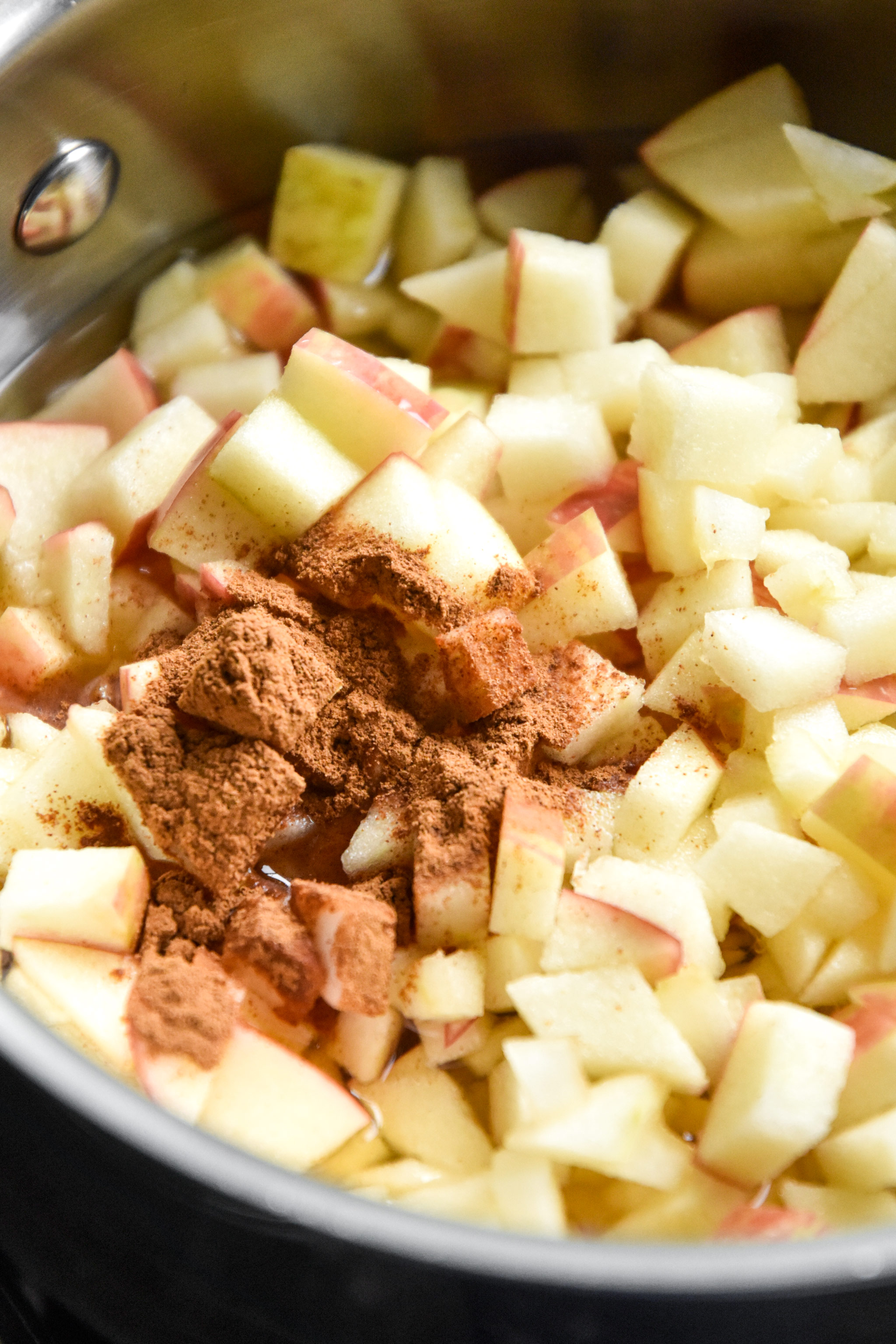 finely diced apples with cinnamon in a saucepan