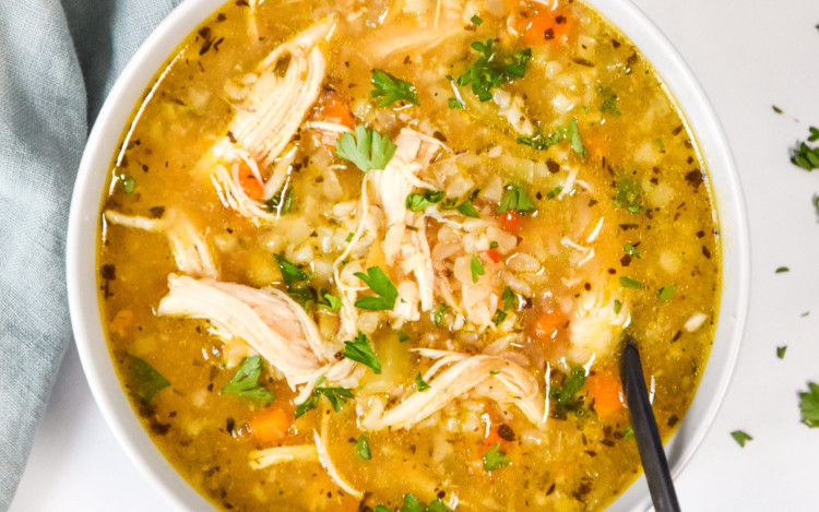 instant pot ginger chicken & rice soup in a bowl with a spoon