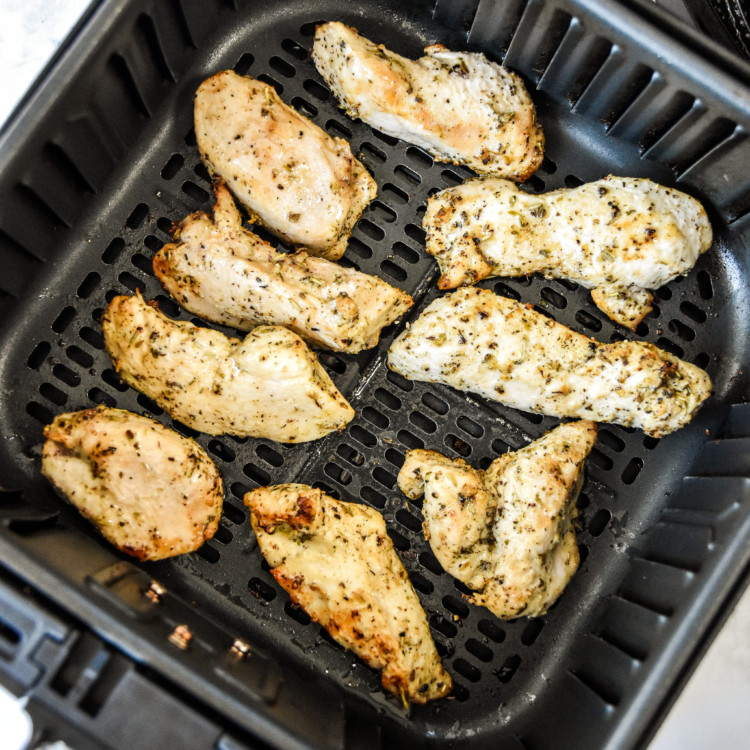 cooked air fryer chicken tenders in the air fryer basket.