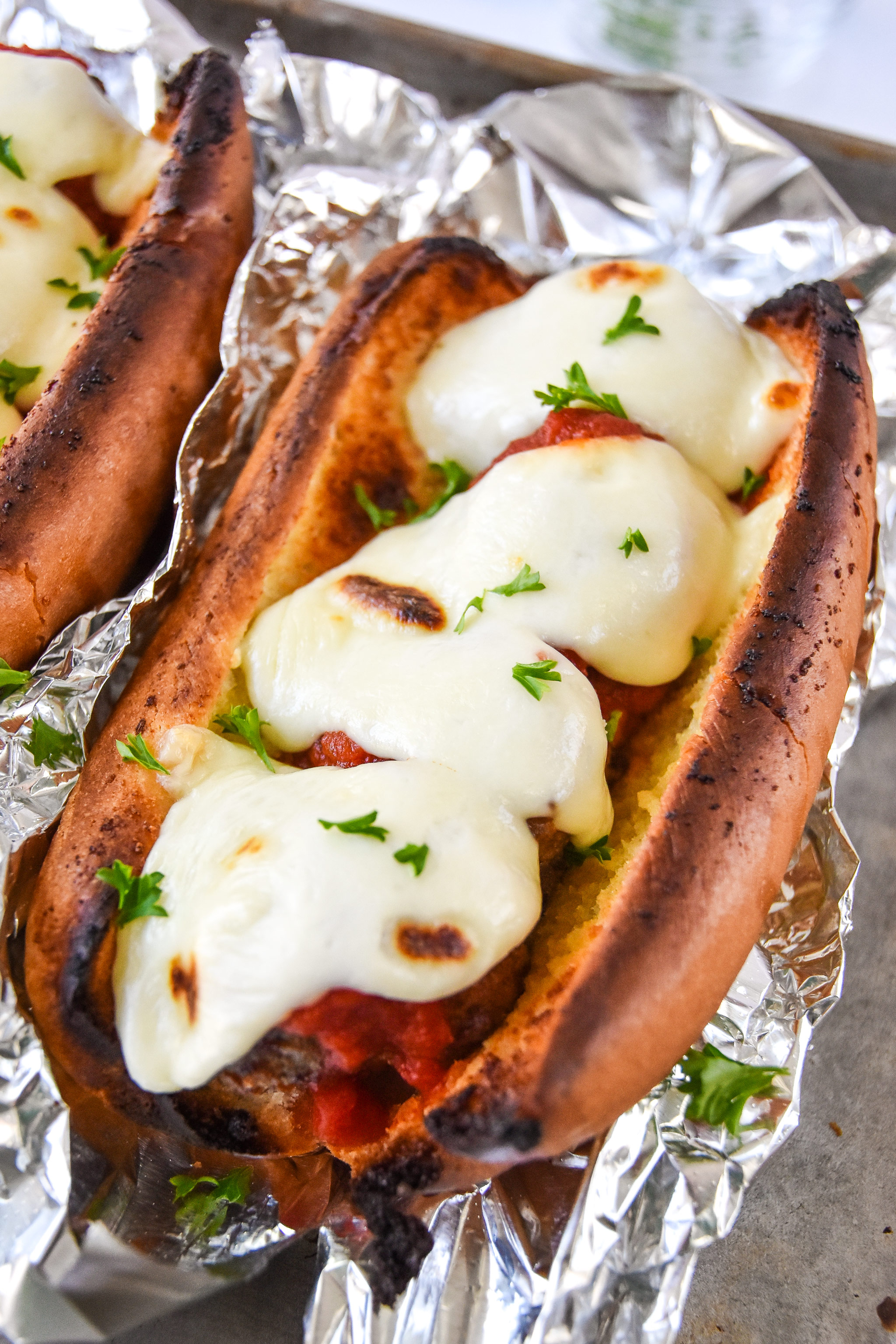 delicious meatball sub sandwich with melted mozzarella ready to be eaten.