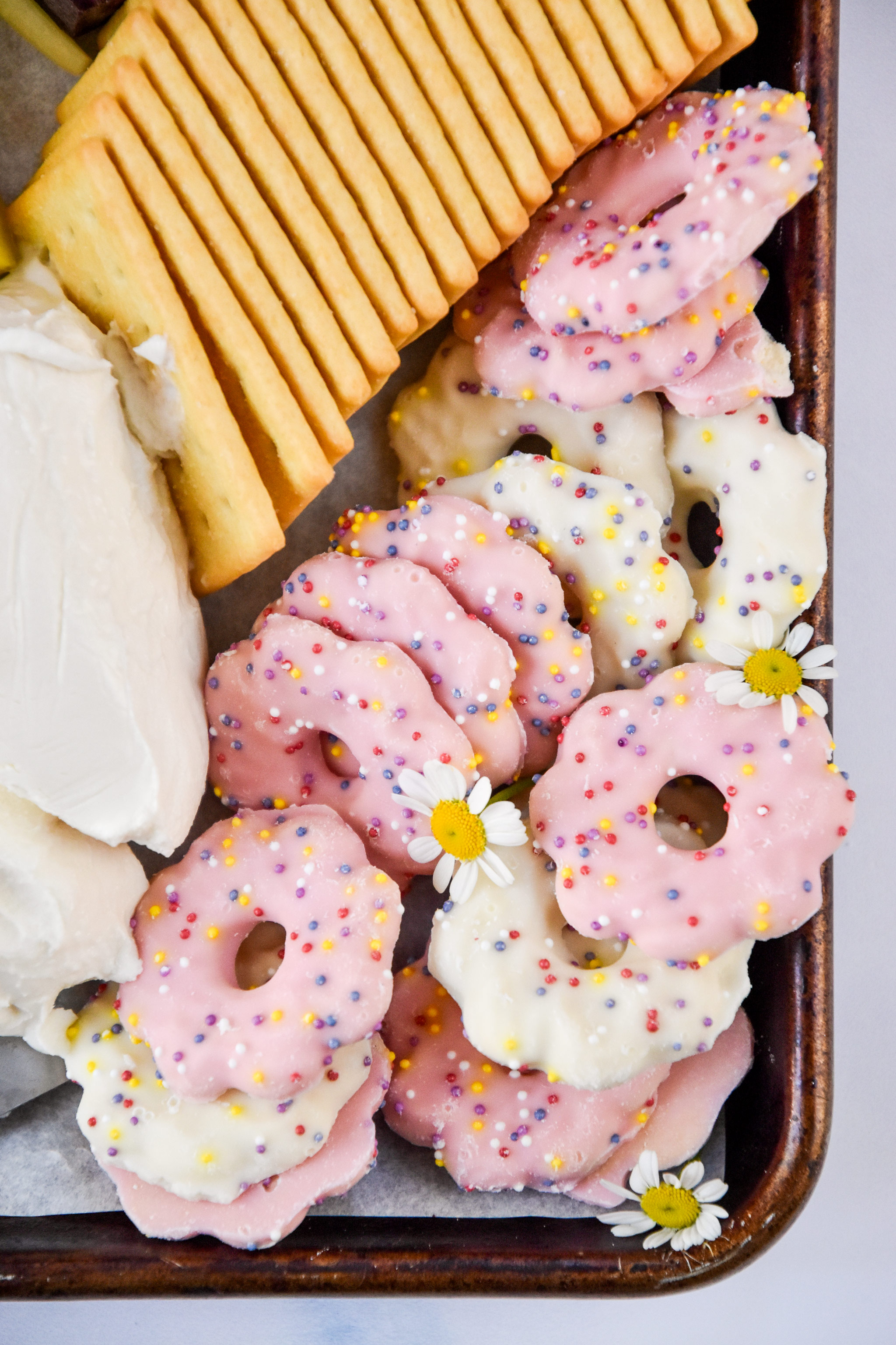 close up of the pink and white cookies on the snack board.