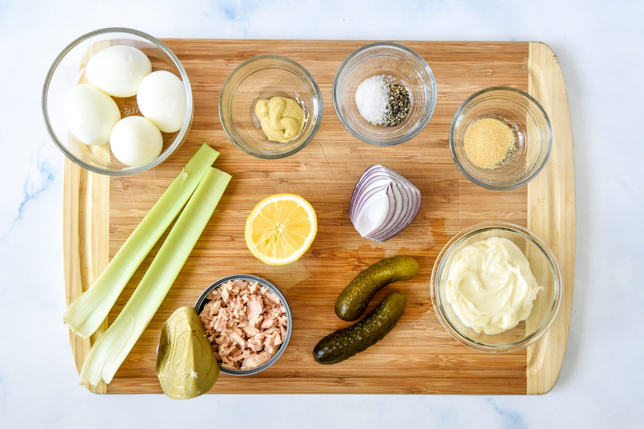 ingredients on a cutting board for the tuna egg salad meal prep.