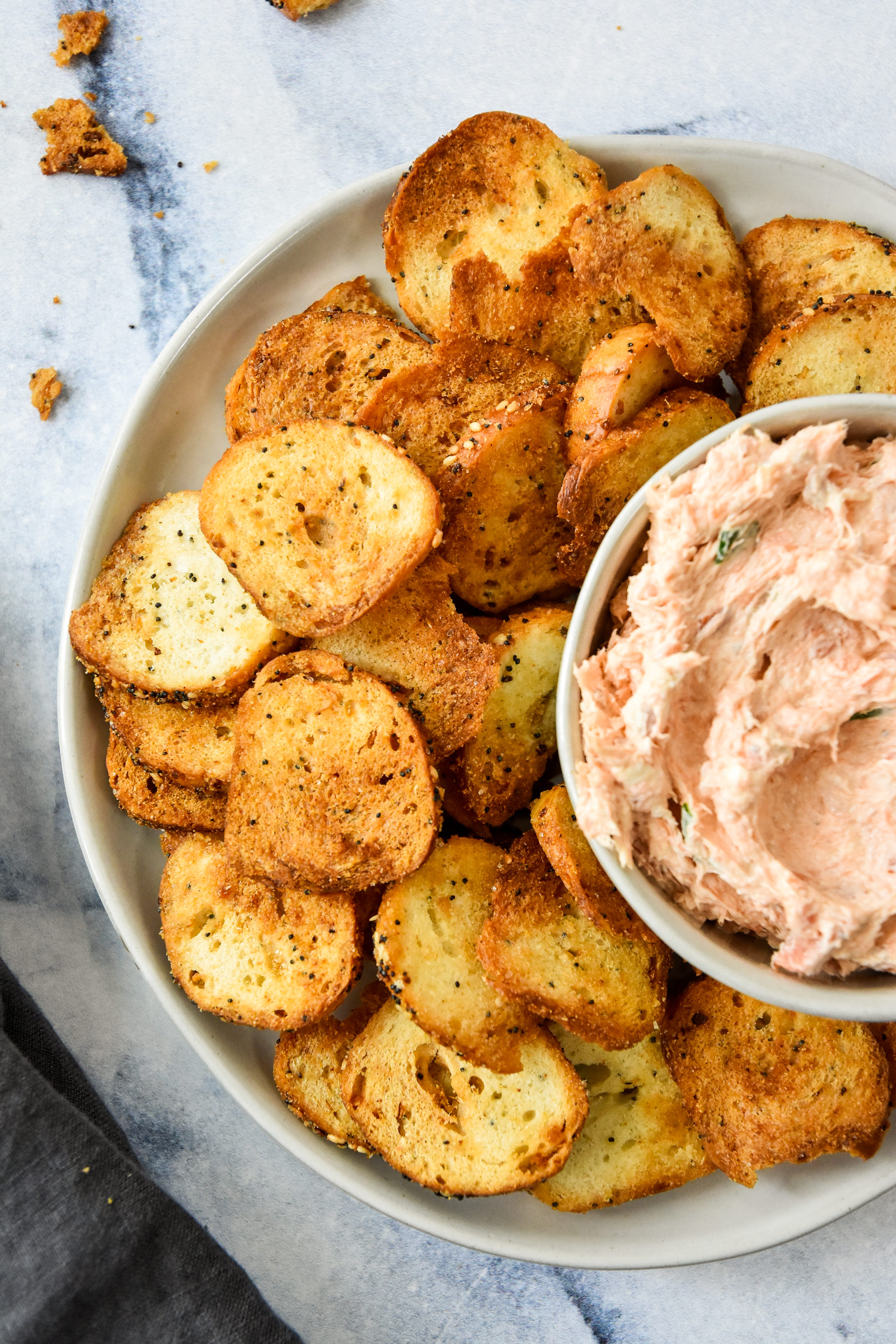 air fryer everything bagel chips on a plate with smoked salmon dip.