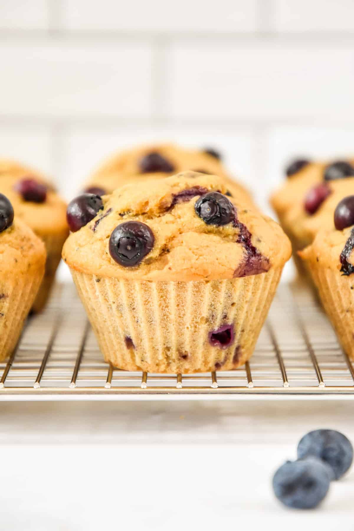 side view of muffins on a cooling rack.