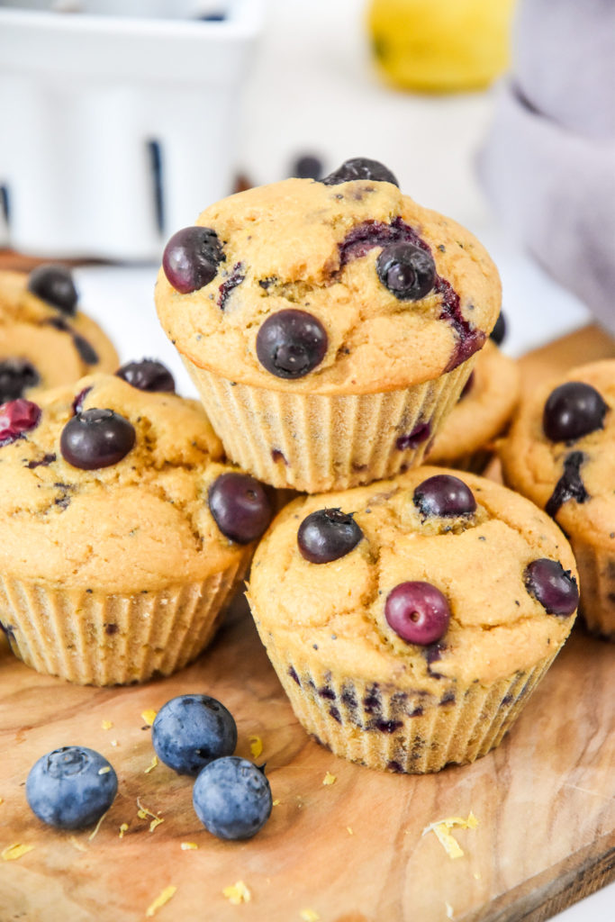 stacked muffins on a cutting board.