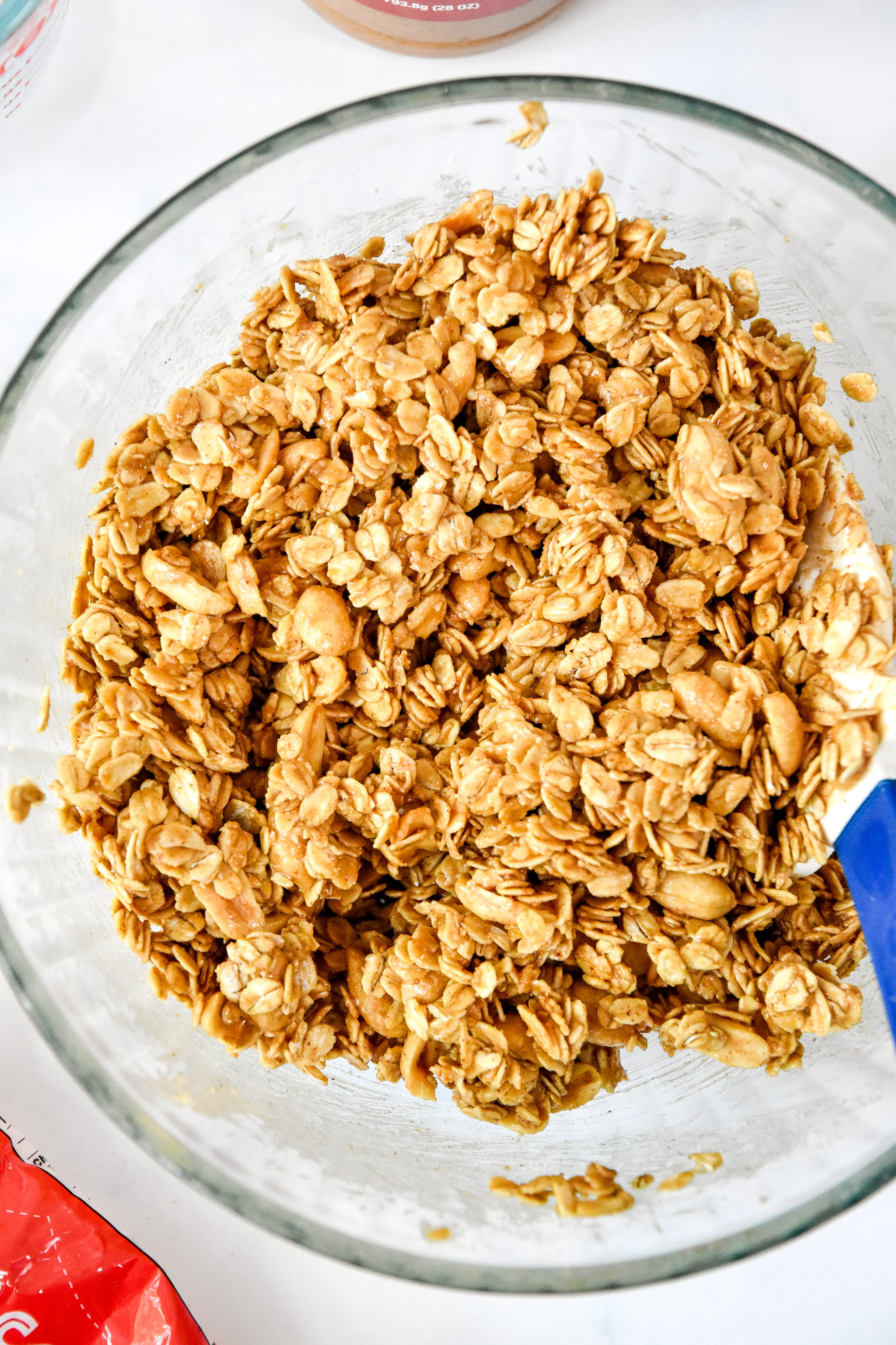 bowl of oats with peanut butter mixture about to go in to the oven to make peanut butter granola.