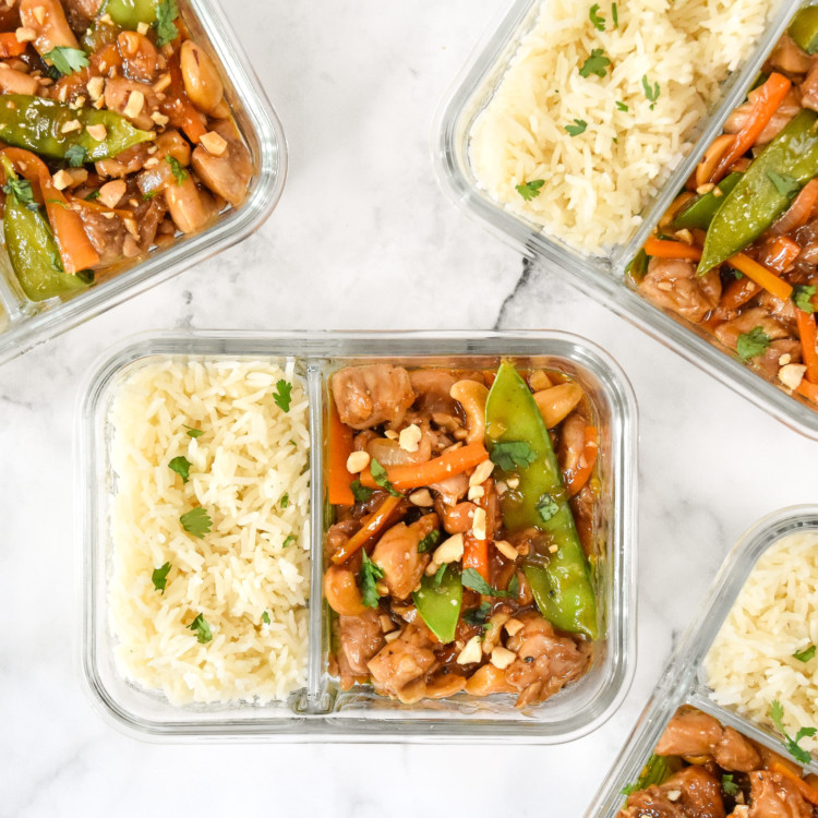 top down shot of easy cashew chicken meal prep in a glass meal prep container with rice.