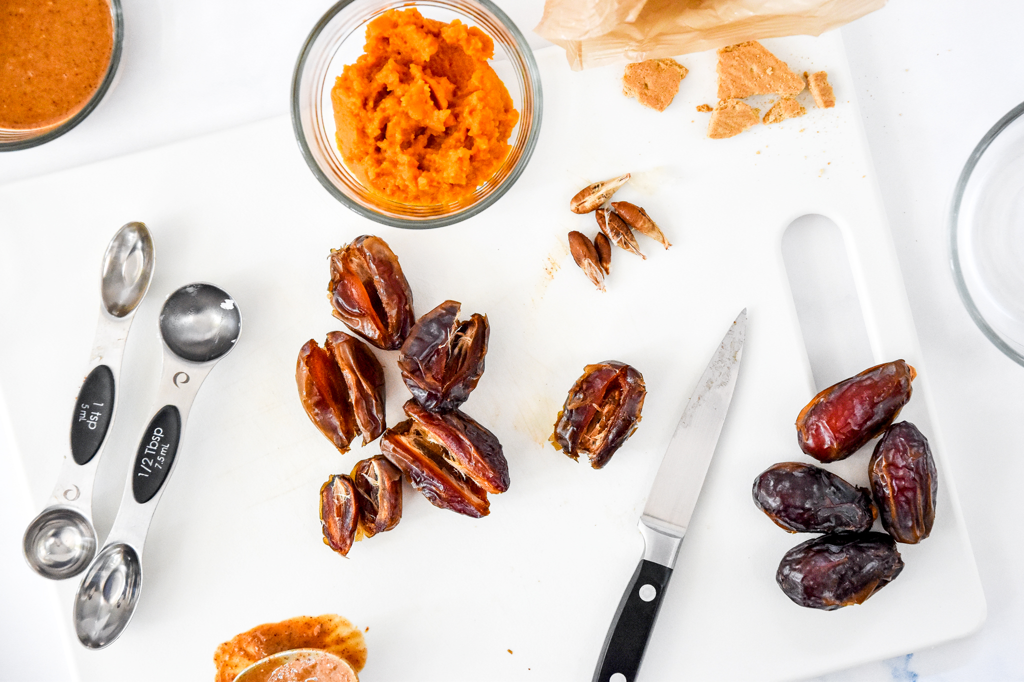removing pits from dates in order to make the pumpkin spice date balls.