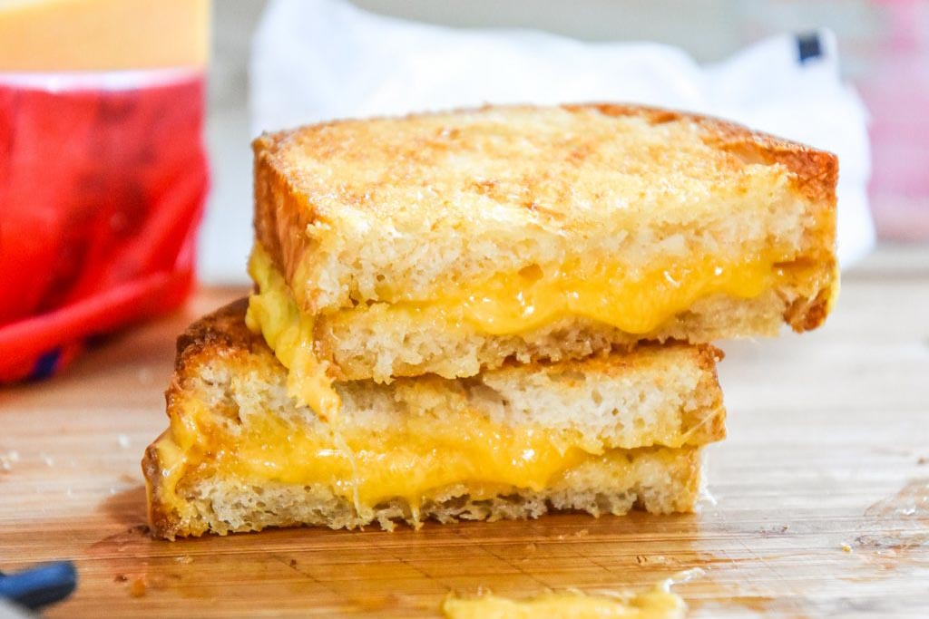 air fryer grilled cheese sandwich on a cutting board.