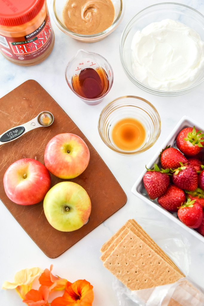 flatlay of tools and ingredients to make peanut butter greek yogurt fruit dip.