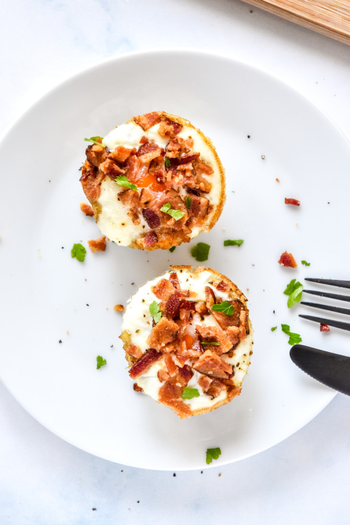 two tater tot crust baked egg cups on a white plate.