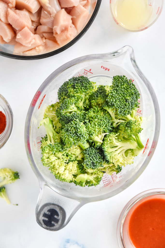cut broccoli florets in a measuring cup.