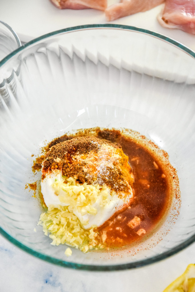 chicken marinade ingredients in a large glass bowl.