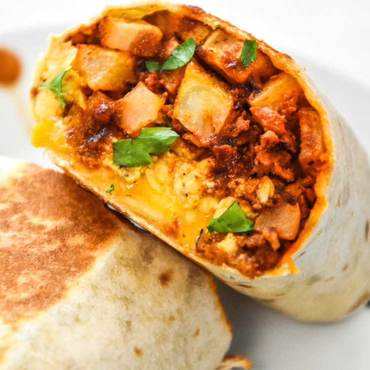 meal prep soy chorizo breakfast burritos cut in half and zoomed in on inside fillings.