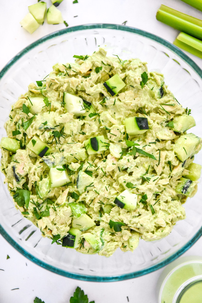 a big clear glass bowl of green goddess tuna salad.
