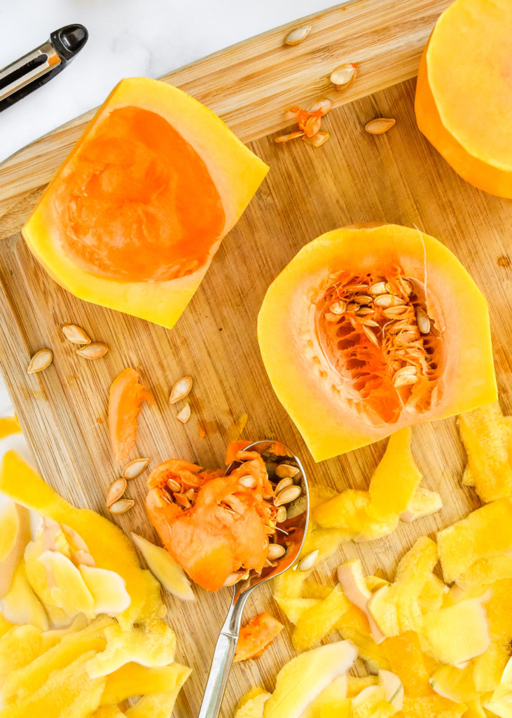 peeling and cutting butternut squash on a cutting board.