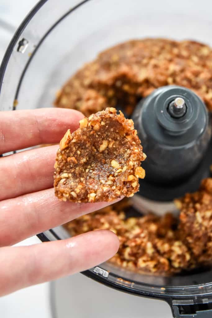 squishing the date nut mixture together in hand.