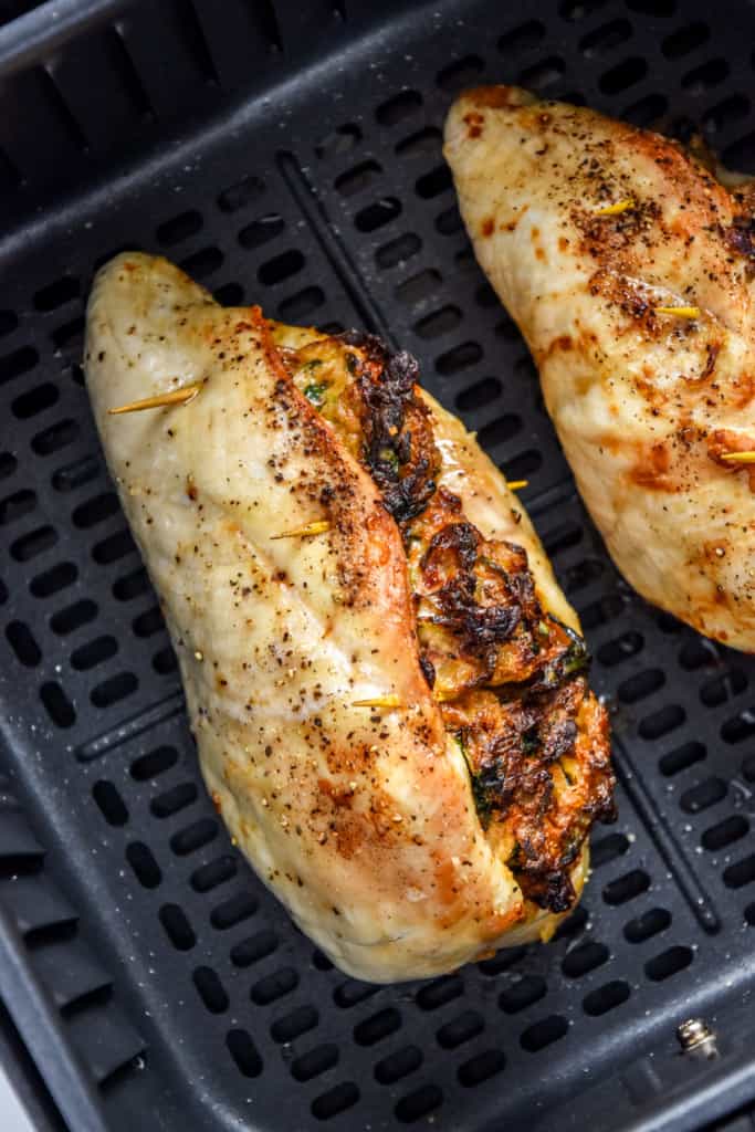 cooked air fryer stuffed chicken breast in the air fryer basket.