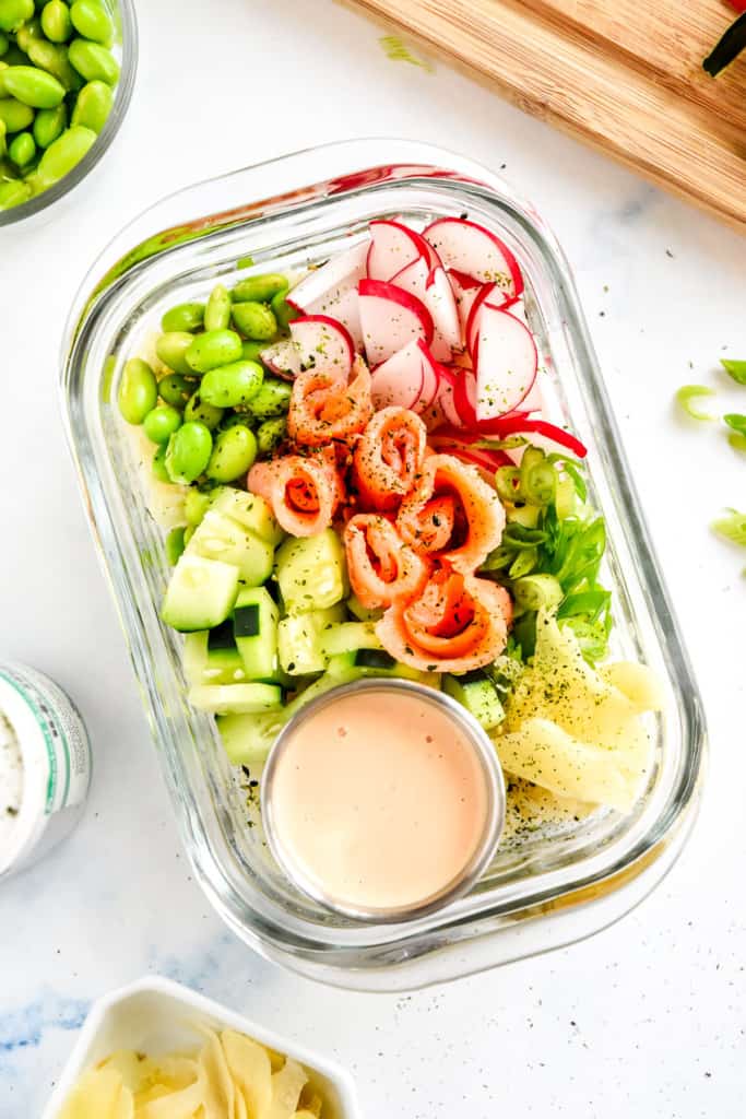 easy smoked salmon rice bowls in a glass meal prep container.