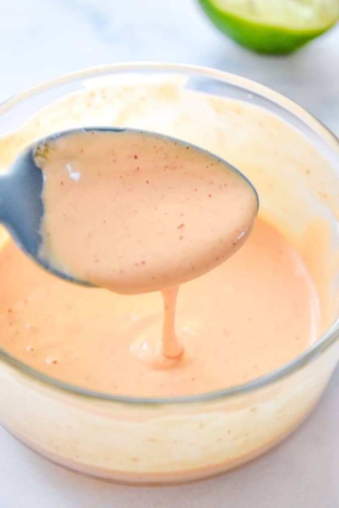 mixed up spicy lime mayo sauce in a small glass bowl.