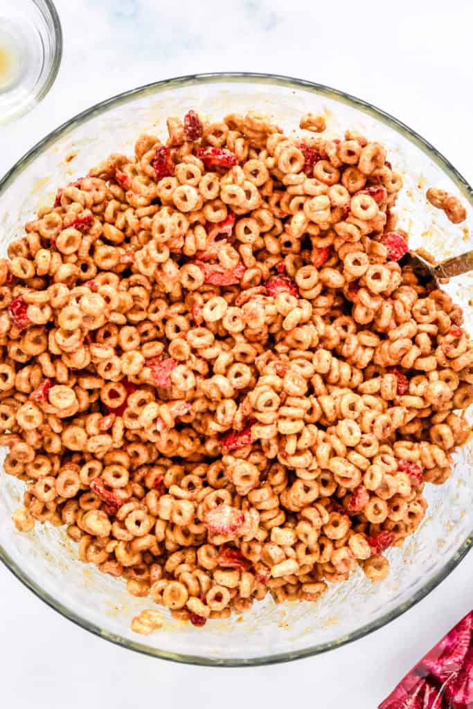 a big bowl of cheerios mixed with honey and peanut butter for the cheerios bars.