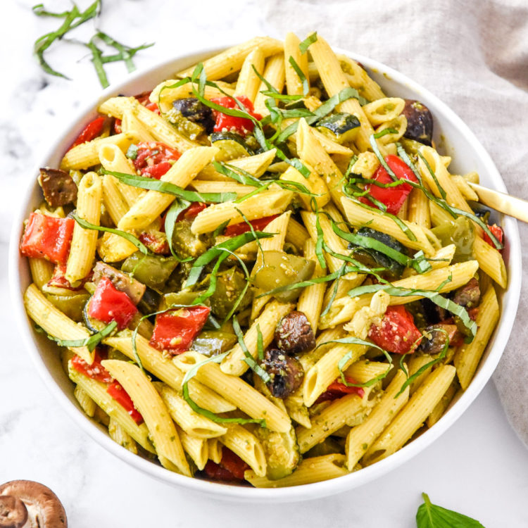mixed roasted veggie pesto pasta in a large mixing bowl.