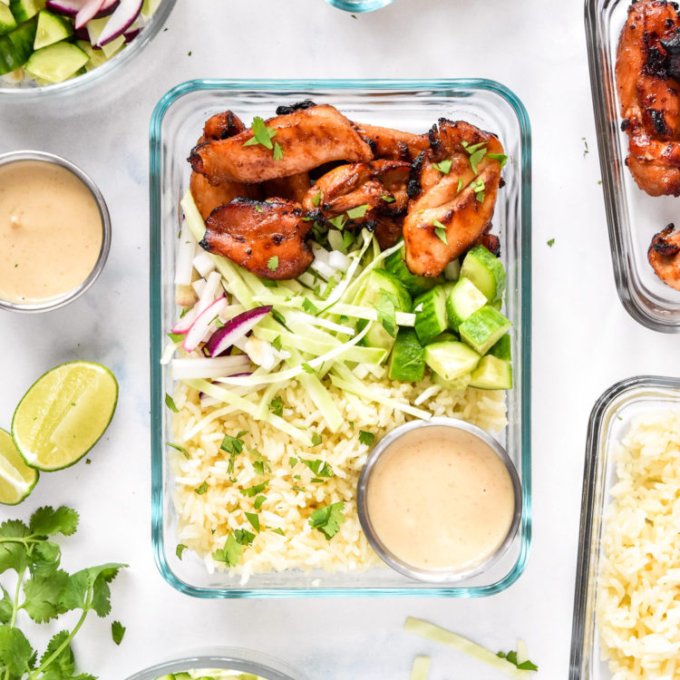 air fryer honey sriracha chicken bowls with dressing and cilantro on top.