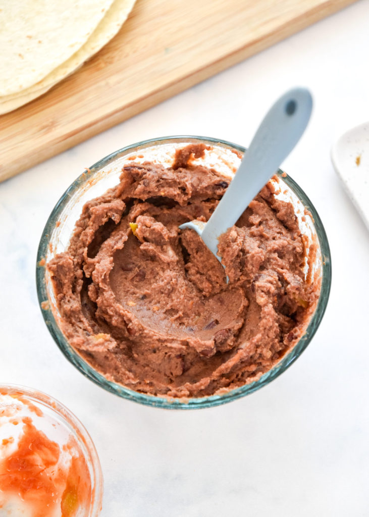 mixed beans and salsa in a bowl for the chicken bean burritos.