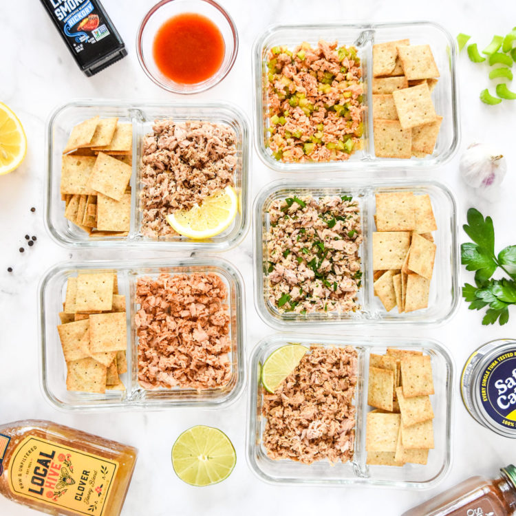 DIY flavored tuna packets with crackers in glass meal prep containers.