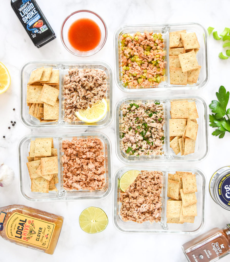DIY flavored tuna packets with crackers in glass meal prep containers.