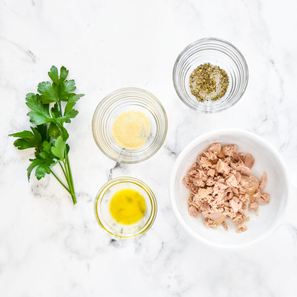 ingredients required to make the garlic herb flavored tuna packet including garlic powder and italian seasoning.