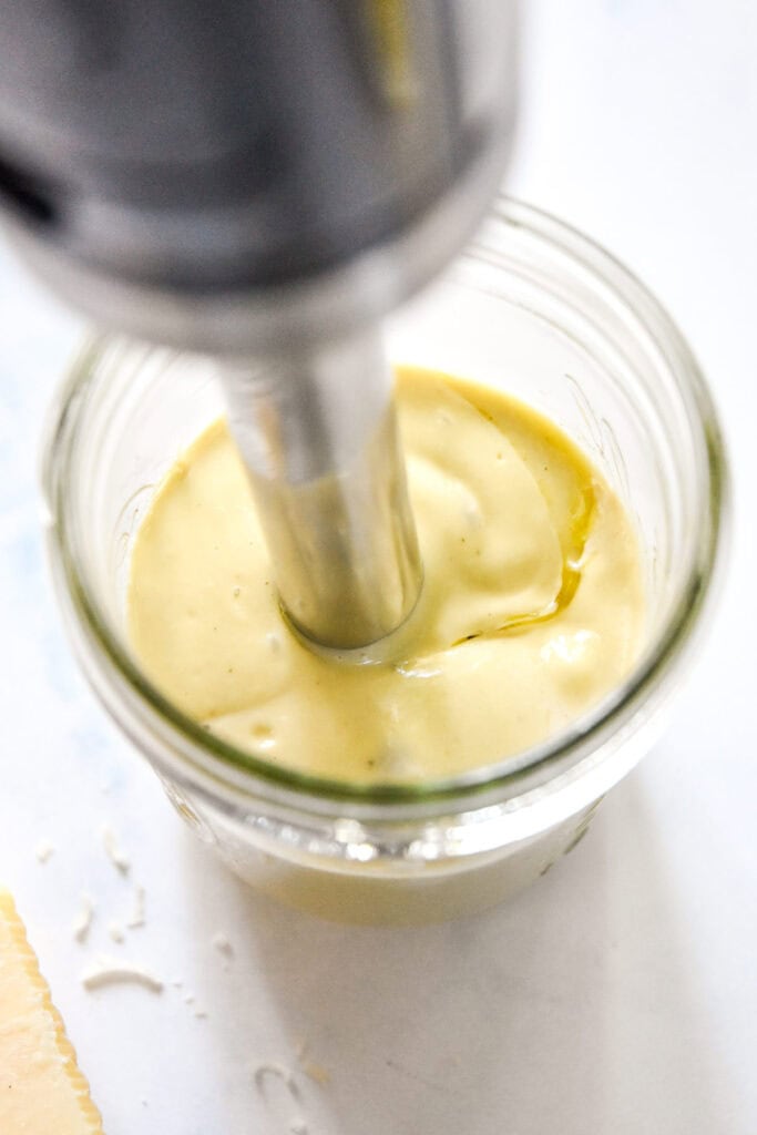 blending up caesar salad dressing with an immersion blending.